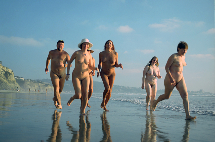Running nude and wild on an empty beach