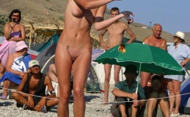 326-Tanned-woman-shows-off-shaved-pussy-for-crowd.jpg