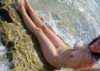 Nude cutie cooling her gorgeous body in the sea water
