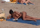 Sexy babe caught topless on the beach reading