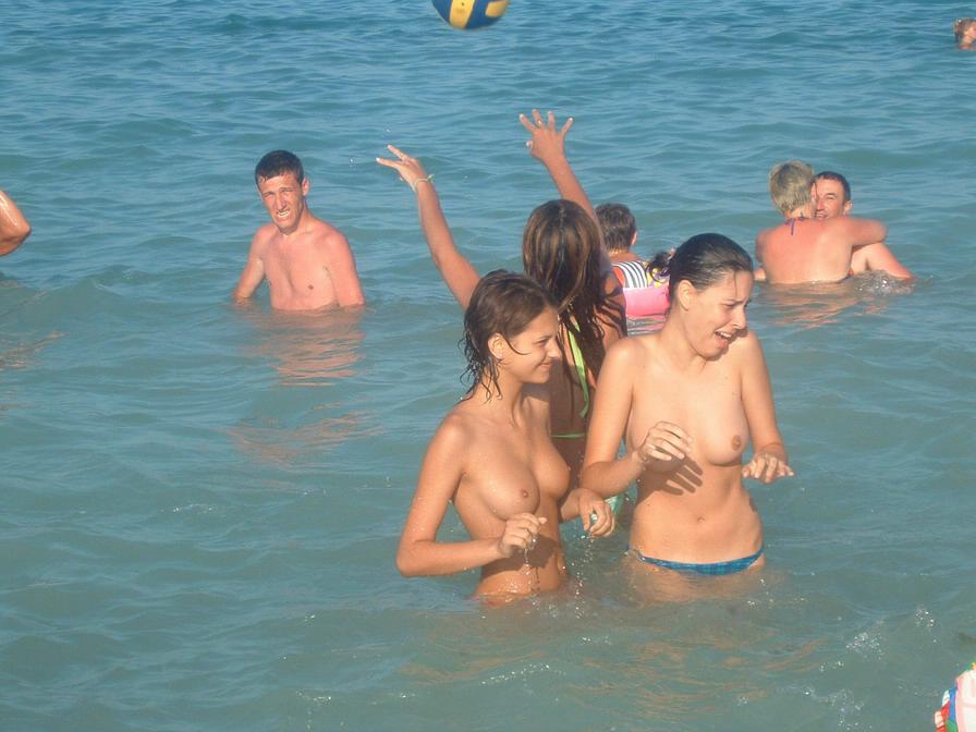 Topless babes caught having fun in the water