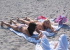 Braless babes tanning on the hot sands