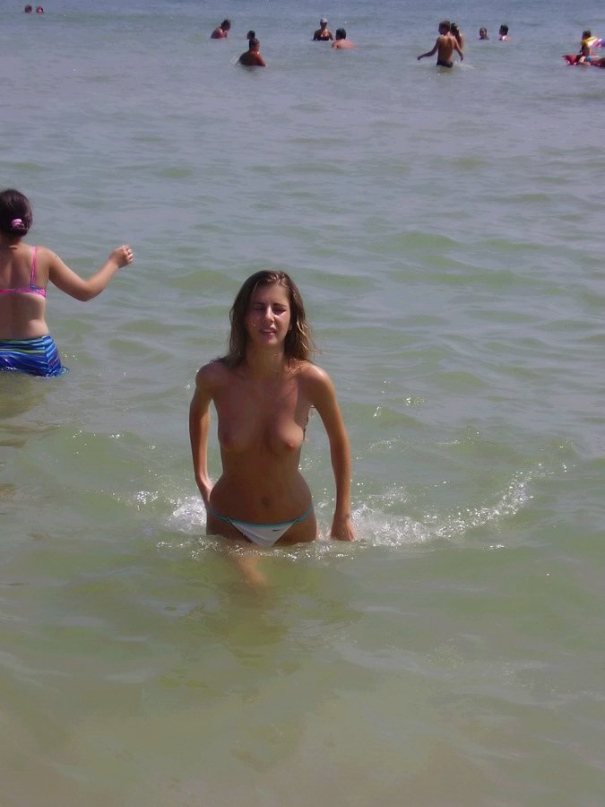 Teen goes topless in the water