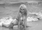 Flirty girl posing playfully in the sea