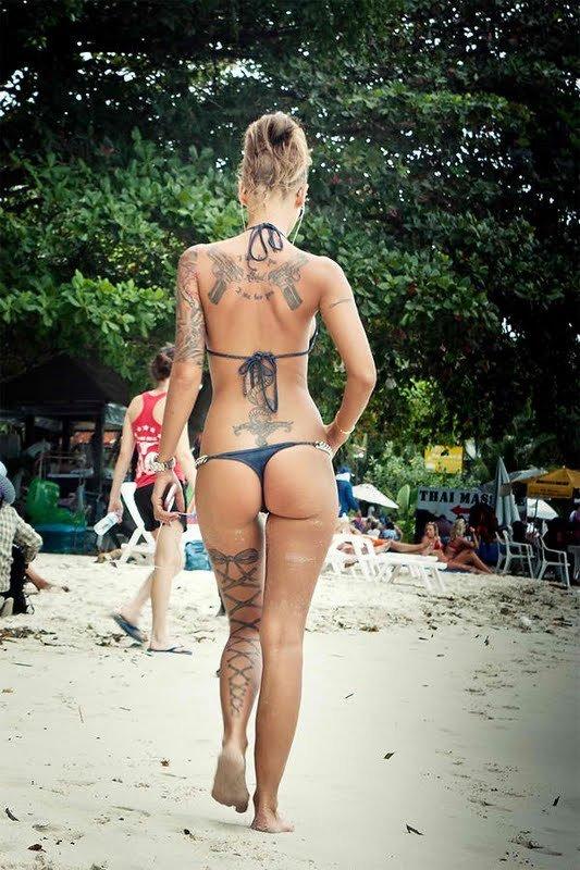 Tattooed blonde showing her nice ass in a thong bikini